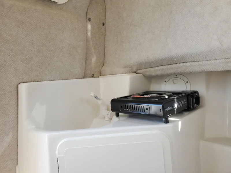 Slide: The Image of Interior of 2022 Sailfish 220 WAC boat with portable stove. - 7