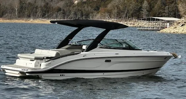 Slide: The Image of 2024 Sea Ray SLX 280 boat on a lake with a black canopy. - 12