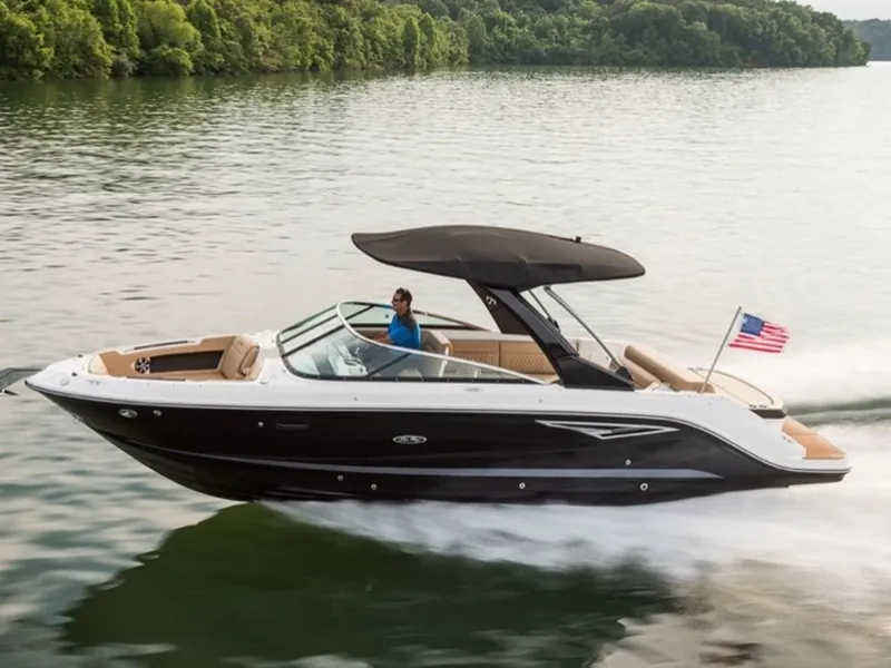 Slide: The Image of 2024 Sea Ray SLX 280 boat cruising on a lake with lush green trees in the background. - 13