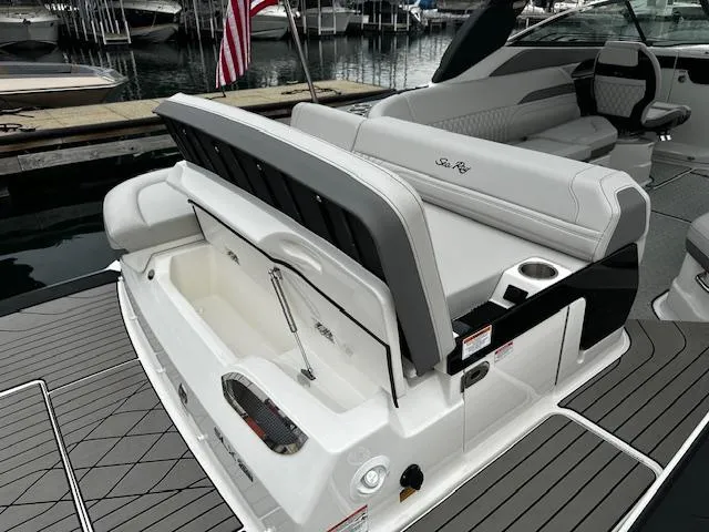 Slide: The Image of 2024 Sea Ray SLX 280 boat with open storage compartment and luxurious seating. - 14