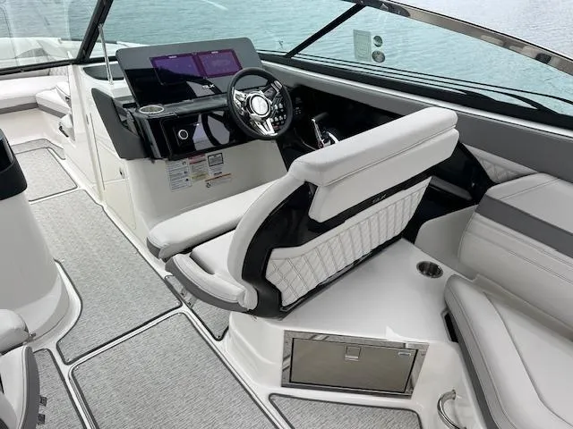 Slide: The Image of 2024 Sea Ray SLX 280 boat interior with modern helm and luxurious seating. - 25