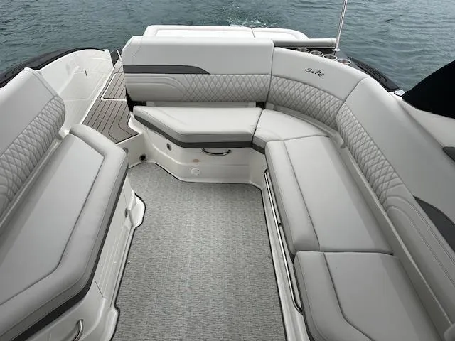 Slide: The Image of 2024 Sea Ray SLX 280 boat interior with luxurious seating and water in the background. - 26