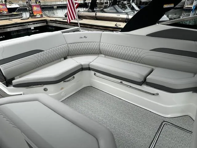 Slide: The Image of 2024 Sea Ray SLX 280 boat interior with luxurious seating at a marina. - 30