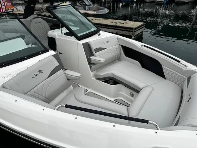 Slide: The Image of 2024 Sea Ray SLX 280 boat with luxurious seating at a marina. - 32