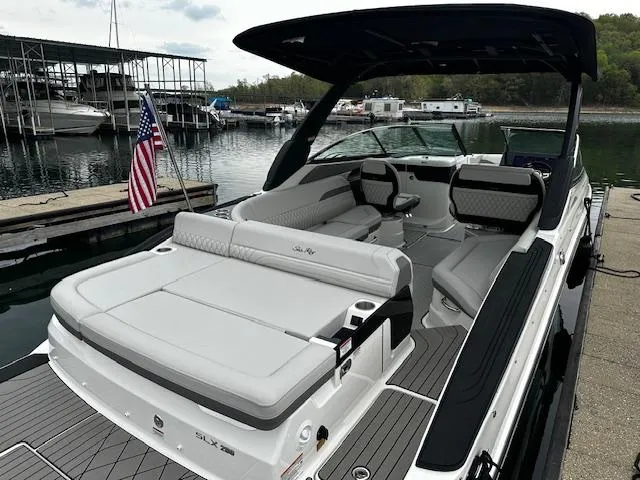Slide: The Image of 2024 Sea Ray SLX 280 luxury boat docked at a marina. - 34