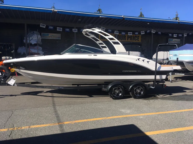 Slide: The Image of 2025 Chaparral 23 SSi boat on a trailer in a dealership lot. - 2