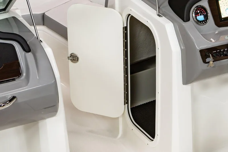 Slide: The Image of 2025 Chaparral 23 SSi boat interior storage compartment with open door. - 37