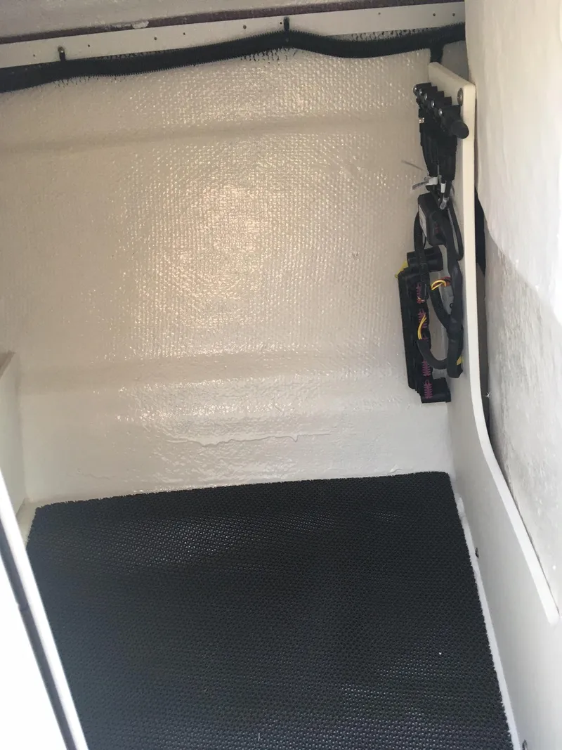 Slide: The Image of Interior cabin of 2025 Chaparral 23 SSi boat with black flooring. - 7