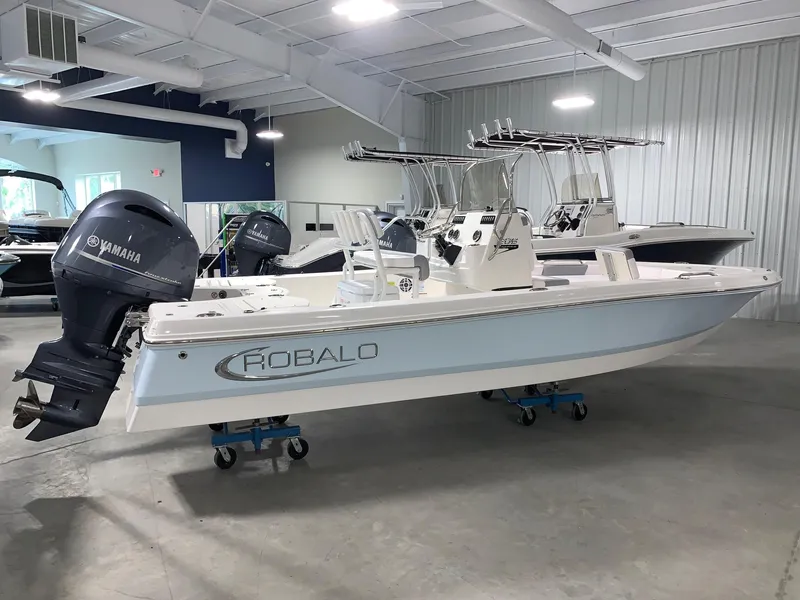 Slide: The Image of 2024 Robalo 206 Cayman boat with Yamaha outboard motor in showroom. - 0