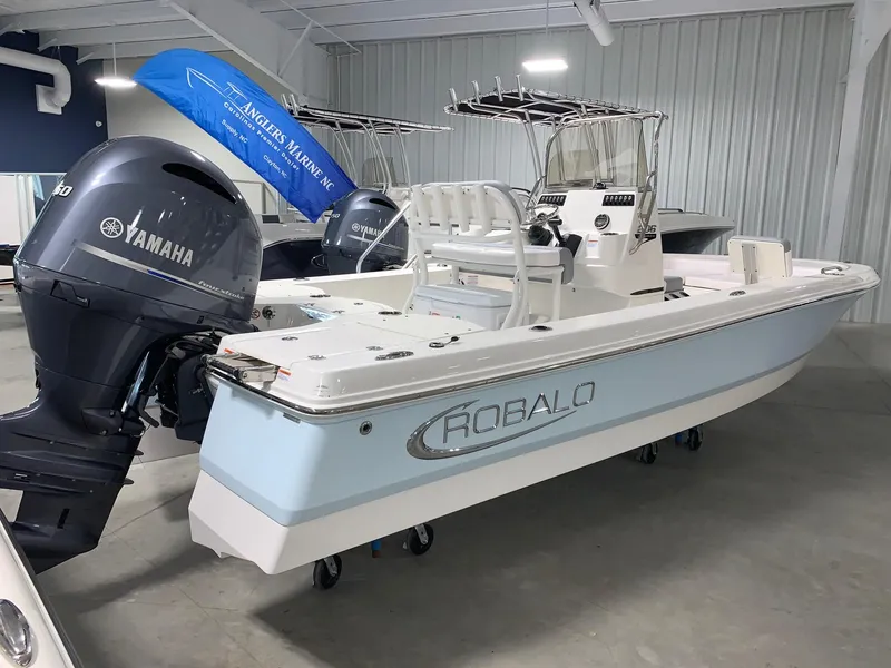 Slide: The Image of 2024 Robalo 206 Cayman boat with Yamaha outboard motor in showroom. - 1