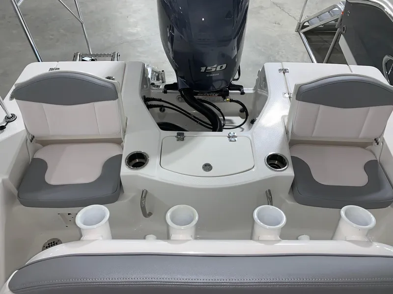 Slide: The Image of 2024 Robalo 206 Cayman boat interior with dual seats and Yamaha 150 engine. - 11