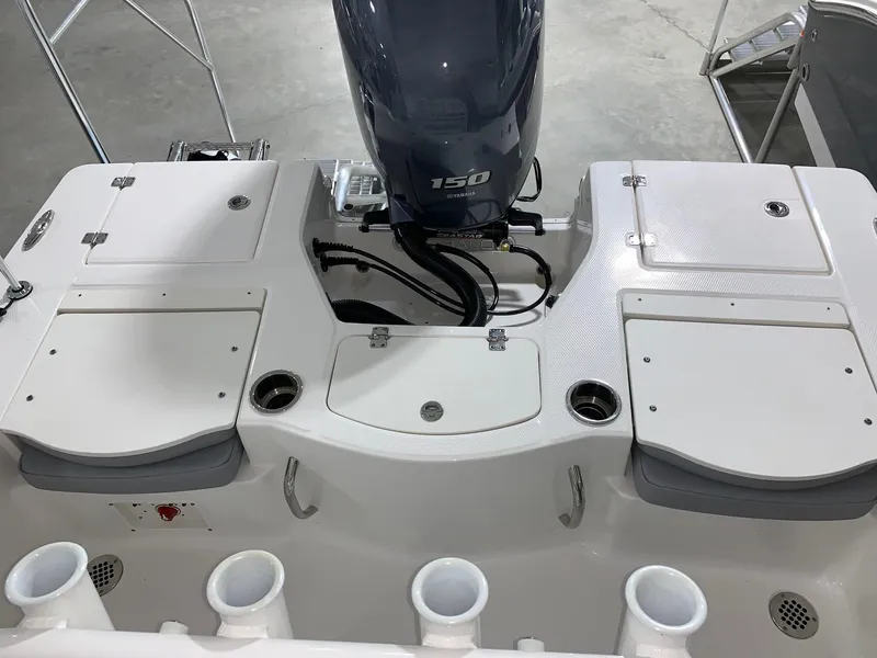 Slide: The Image of 2024 Robalo 206 Cayman boat stern with 150 HP engine and storage compartments. - 12