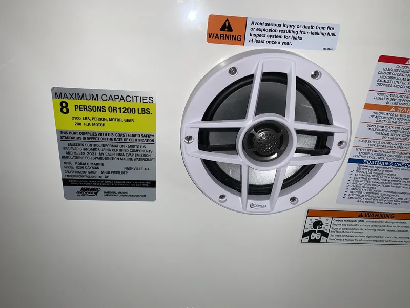 Slide: The Image of 2024 Robalo 206 Cayman boat capacity label and speaker - 13