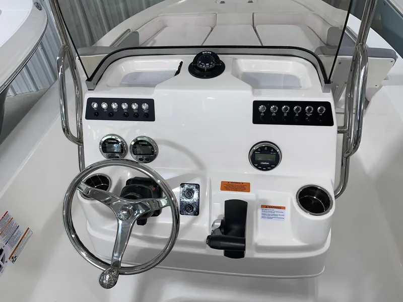 Slide: The Image of 2024 Robalo 206 Cayman boat console with steering wheel and control panel. - 16
