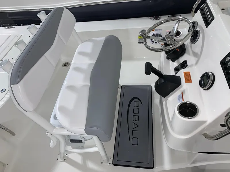 Slide: The Image of 2024 Robalo 206 Cayman boat cockpit with steering wheel and seating. - 17