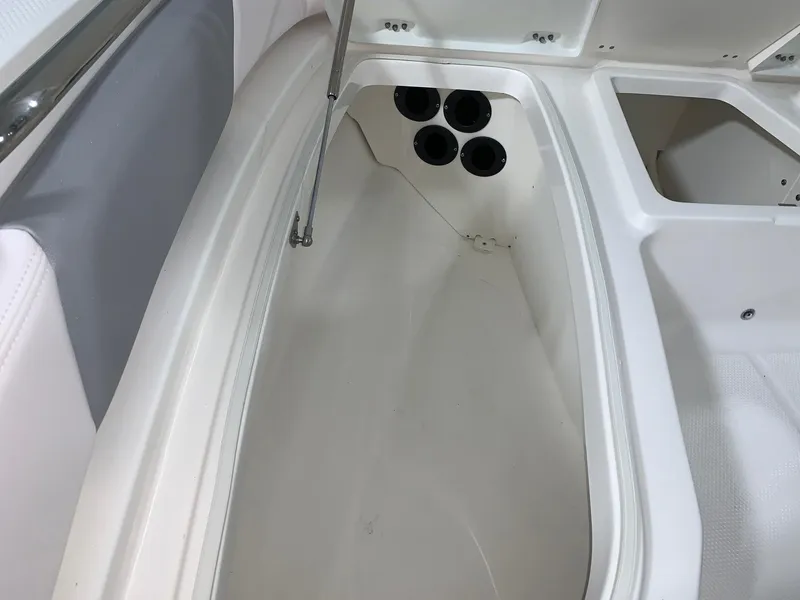 Slide: The Image of 2024 Robalo 206 Cayman boat storage compartment with rod holders. - 23