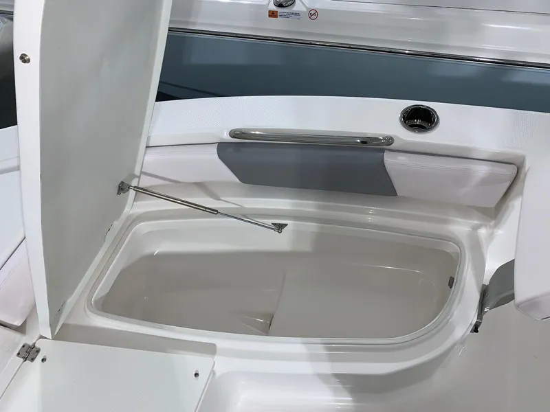 Slide: The Image of 2024 Robalo 206 Cayman storage compartment with open lid. - 24