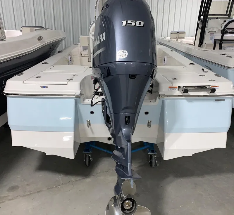 Slide: The Image of 2024 Robalo 206 Cayman boat with Yamaha 150 outboard motor in a showroom. - 3