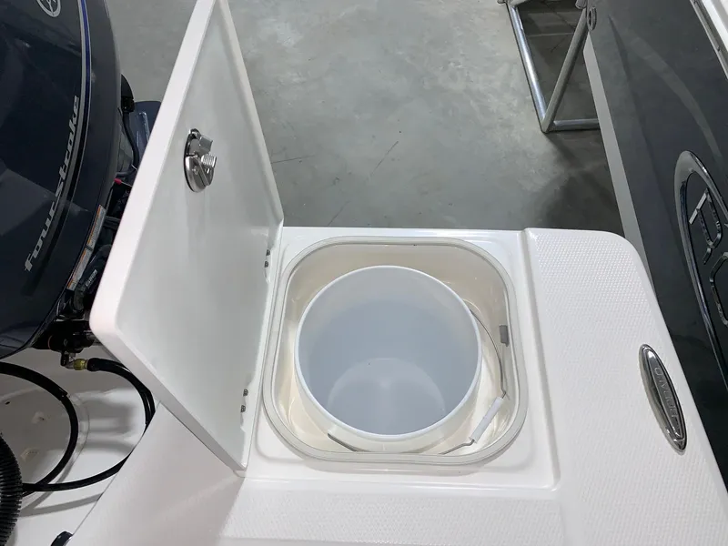 Slide: The Image of 2024 Robalo 206 Cayman livewell compartment with open lid. - 8