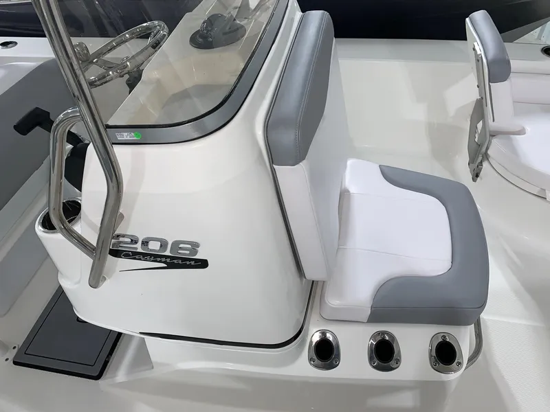 Slide: The Image of 2024 Robalo 206 Cayman boat interior with cushioned seating and console. - 18
