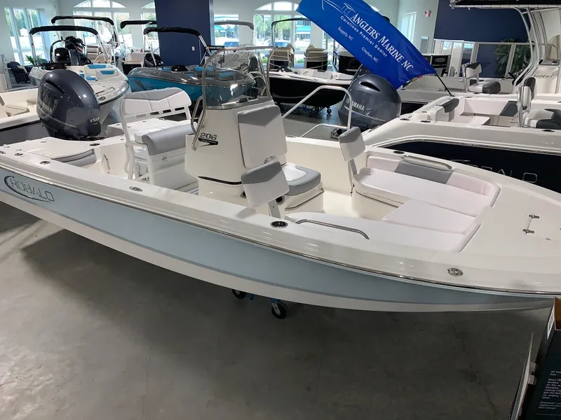 Slide: The Image of 2024 Robalo 206 Cayman boat on display in showroom. - 2