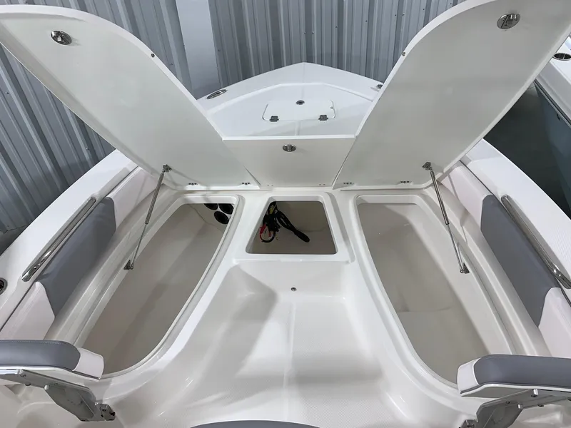 Slide: The Image of 2024 Robalo 206 Cayman boat with open storage compartments. - 20