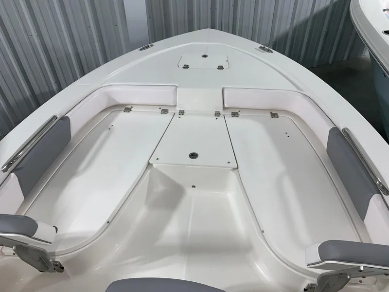 Slide: The Image of 2024 Robalo 206 Cayman boat interior with cushioned seating and storage compartments. - 23