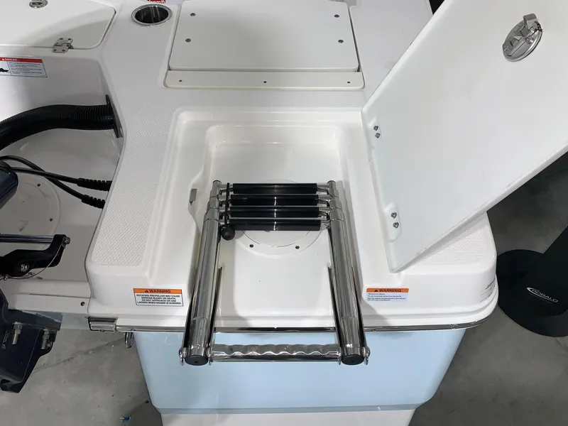 Slide: The Image of 2024 Robalo 206 Cayman boat with a foldable swim ladder. - 26