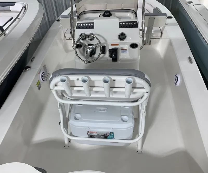 Slide: The Image of 2024 Robalo 206 Cayman center console boat interior with steering wheel and rod holders. - 4