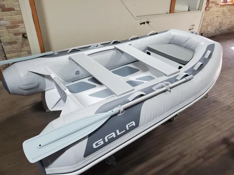 The Image of 2023 Gala A270D inflatable boat with oars in an indoor setting. - 0