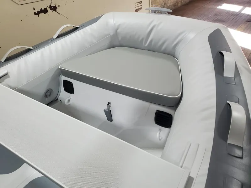 Slide: The Image of 2023 Gala A270D inflatable boat interior with cushioned seating. - 2
