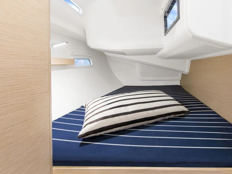 Slide: The Image of 2025 Hanse 388 yacht cabin with striped bedding and modern design. - 19