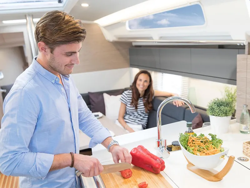 Slide: The Image of Man cooking in modern Hanse 388 yacht kitchen, 2025 model. - 18