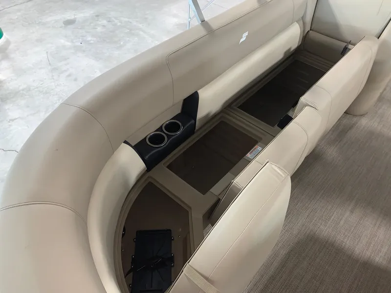 Slide: The Image of 2024 Starcraft LX20 R boat interior with beige seating and cup holders. - 7