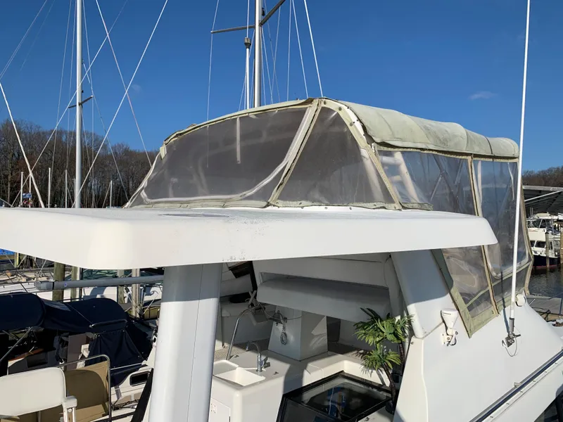 Slide: The Image of 1992 Silverton 34 Aft Cabin Motor Yacht with enclosed flybridge, docked at marina. - 11