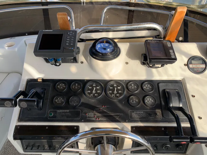 Slide: The Image of Control panel of a 1992 Silverton 34 Aft Cabin Motor Yacht with navigation instruments. - 13
