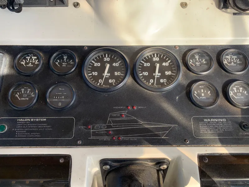 Slide: The Image of 1992 Silverton 34 Aft Cabin Motor Yacht dashboard with gauges and controls. - 14