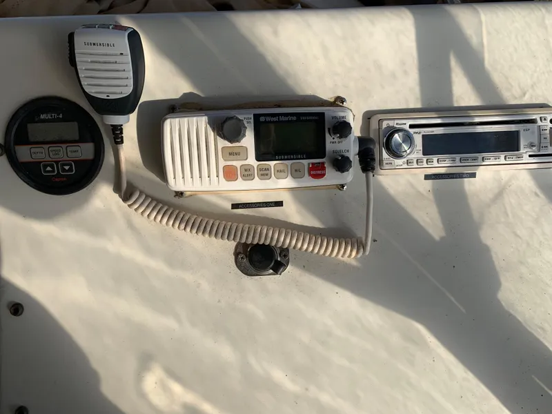 Slide: The Image of 1992 Silverton 34 Aft Cabin Motor Yacht dashboard with radio and communication equipment. - 19