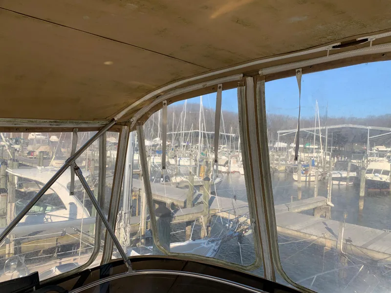 Slide: The Image of 1992 Silverton 34 Aft Cabin Motor Yacht docked at a marina, view from inside. - 22