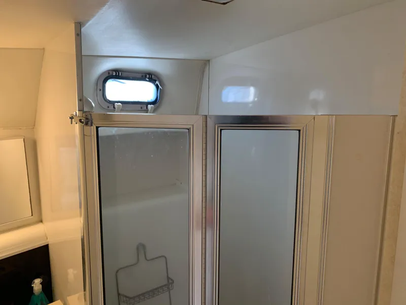 Slide: The Image of Shower area inside a 1992 Silverton 34 Aft Cabin Motor Yacht, featuring a small window. - 30