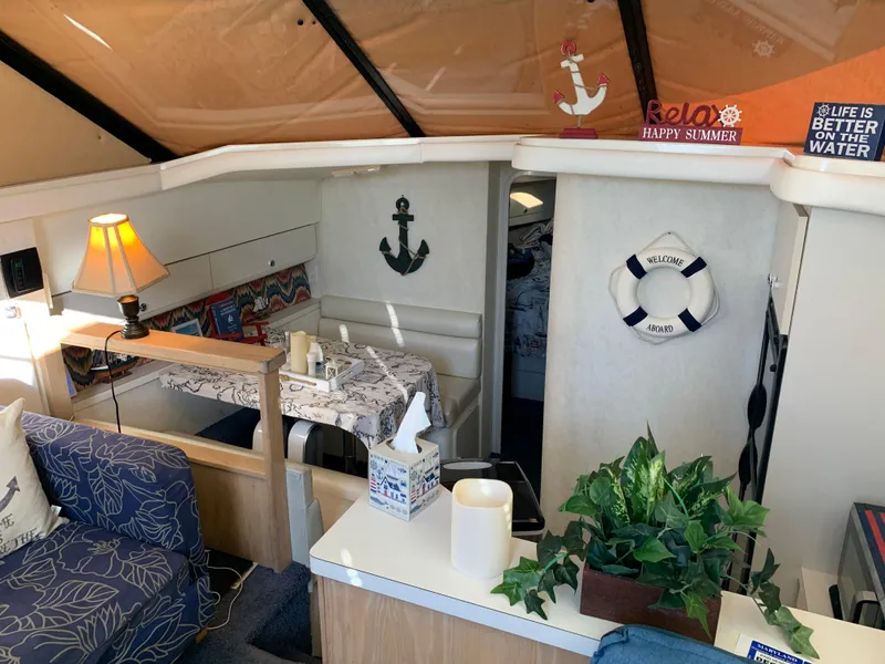 Slide: The Image of Interior of 1992 Silverton 34 Aft Cabin Motor Yacht with nautical decor and cozy seating. - 37