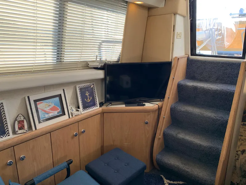 Slide: The Image of Interior of 1992 Silverton 34 Aft Cabin Motor Yacht with TV, stairs, and decor. - 38