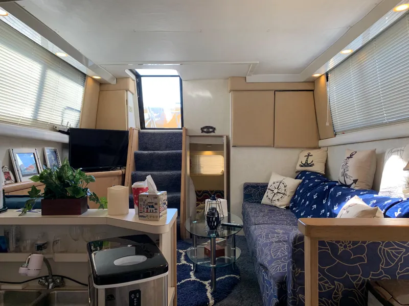 Slide: The Image of Interior of a 1992 Silverton 34 Aft Cabin Motor Yacht, featuring cozy seating and nautical decor. - 40