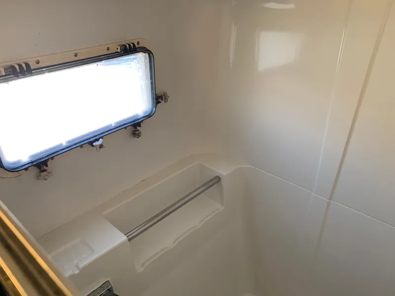 Slide: The Image of 1992 Silverton 34 Aft Cabin Motor Yacht bathroom with window and handrail. - 44