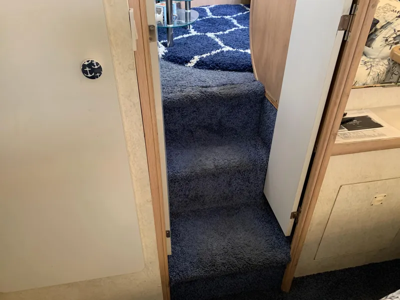Slide: The Image of Interior stairs of 1992 Silverton 34 Aft Cabin Motor Yacht with blue carpet. - 48
