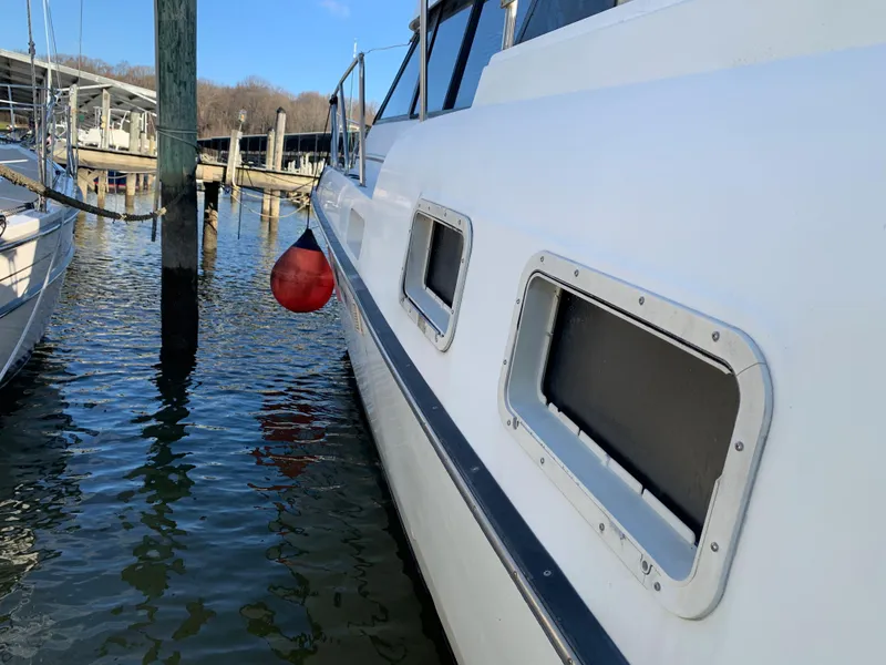 Slide: The Image of 1992 Silverton 34 Aft Cabin Motor Yacht docked at marina, side view. - 5