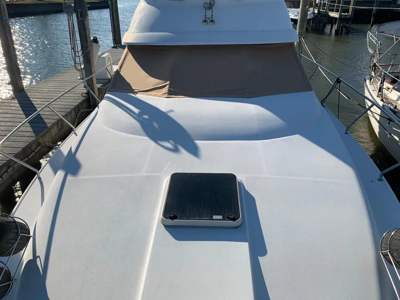 Slide: The Image of 1992 Silverton 34 Aft Cabin Motor Yacht docked, showcasing spacious deck and hatch. - 9