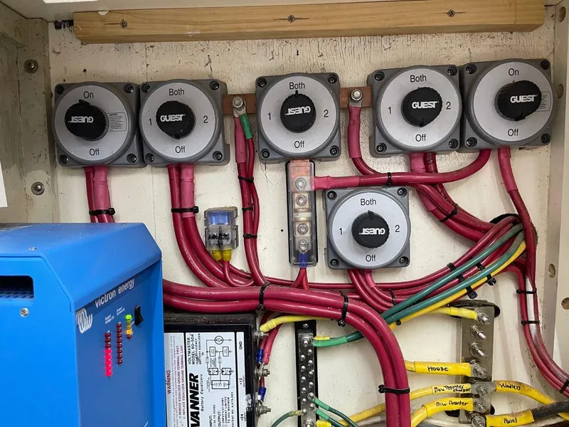 Slide: The Image of Electrical panel of a 1984 Magnum Marine boat with wiring and switches. - 15