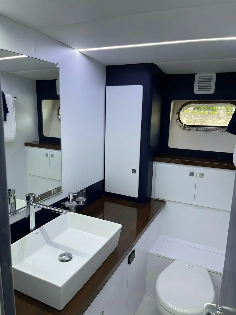 Slide: The Image of Modern bathroom in a 1984 Magnum Marine boat with sleek fixtures. - 5