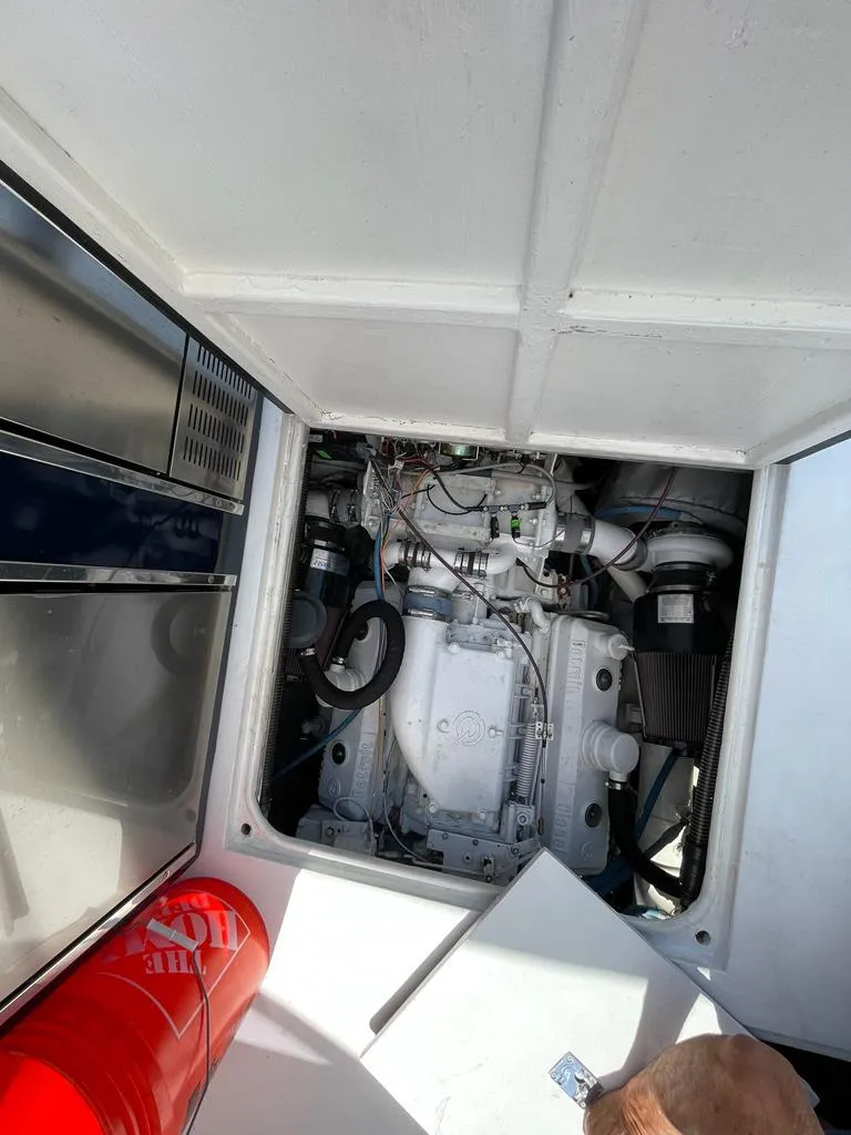 Slide: The Image of 1984 Magnum Marine boat engine compartment with visible components. - 9